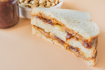 peanut butter sandwich with banana and raspberry jam
