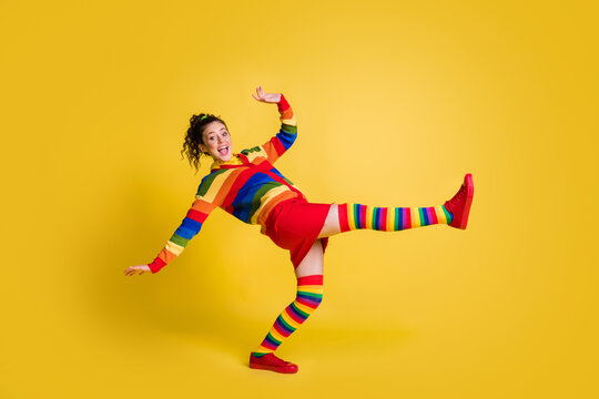 Profile photo of funky lady raise leg clubber party dj wear striped sweater short skirt knee socks shoes isolated yellow color background