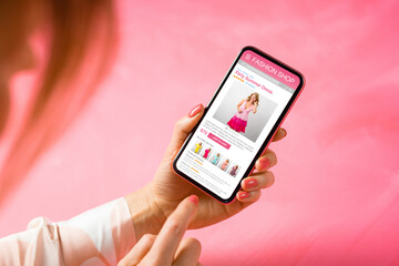 Woman shopping for new dresses online on her mobile phone