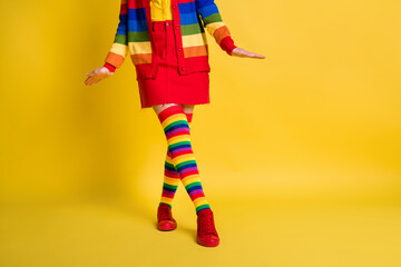 Cropped view of nice fashionable youth girl posing wearing cosy clothing isolated over bright...