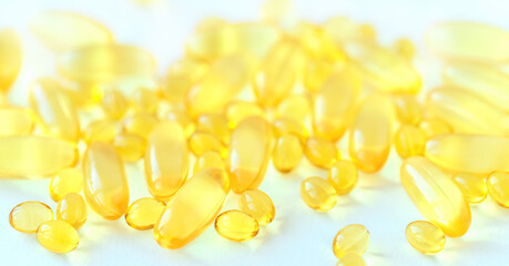 Yellow capcules of fish oil on white background