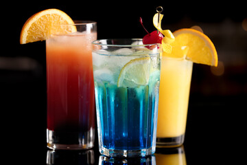 Different delicious cocktails on counter in bar