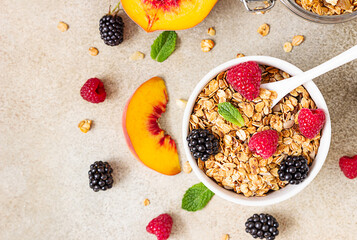 Homemade granola or muesli. Ingredients for healthy breakfast - granola, berries, peach, mint and...