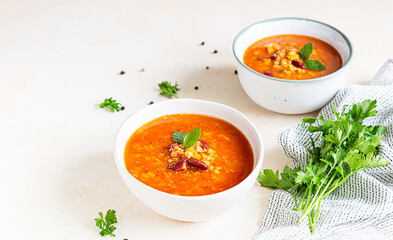Homemade thick lentil and red bean soup with vegetables garnish with herbs. Fit and healthy, vegetarian and vegan meal.