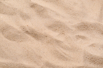 Fototapeta na wymiar Beige clean beach sand as background, closeup. Summer vacation
