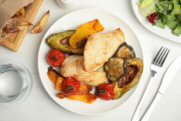 Tasty cooked chicken fillet and vegetables served on white wooden table, flat lay. Healthy meals from air fryer