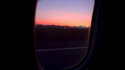 The plane takes off at sunset. View from the airplane window