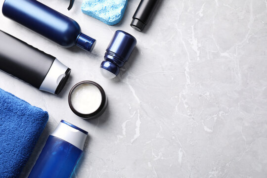Flat lay composition with men's cosmetics on light grey marble background. Space for text
