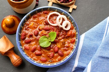 Rajma curry is a popular North Indian Food. Rajma is a socked Red kidney beans cooked with onions, tomatoes and a special blend of spices. Served with Jeera rice or Cumin Rice. With Copy Space.