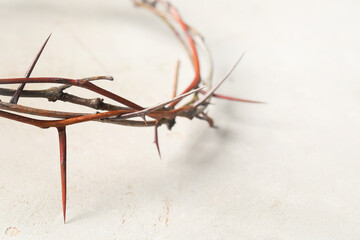 Fototapeta premium Crown of thorns on light background, closeup with space for text. Easter attribute