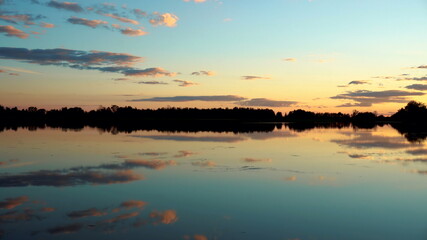 Panorama of the lake at sunset. The lake reflects the sky