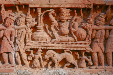 Fototapeta premium Detail of noble man with hookah on litter intricate terracotta carving at Kantaji aka Kantajew medieval hindu temple in Kantanagar, Dinajpur, Bangladesh