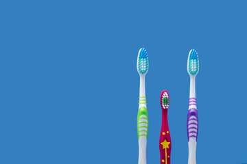 Family concept with large parent toothbrushes and child toothbrush