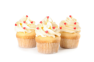 Tasty cupcakes with heart shaped sprinkles for Valentine's Day on white background
