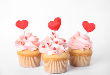 Tasty cupcakes for Valentine's Day on white background