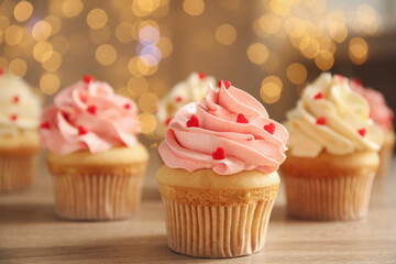Tasty sweet cupcakes on wooden table. Happy Valentine's Day
