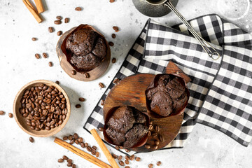 Cupcake. Chocolate muffins on a wooden serving board on a light gray kitchen table. Delicious sweet pastries. Coffee cupcakes on a light background
