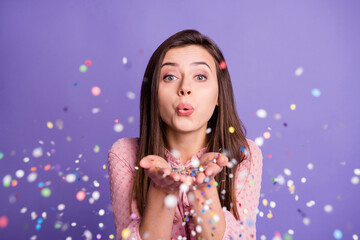 Photo of young beautiful girl pouted lips blow confetti you magic celebration isolated over violet color background