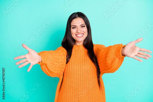 Photo Of Cheerful Funny Woman Hold Open Arms Invite You Hug Wear Orange Sweater Isolated Teal Color Background Wall Mural Deagreez