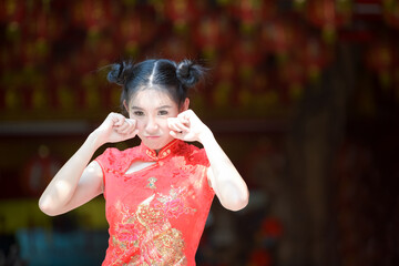 Action portrait beautiful Asian girl wearing Cheongsam red dress. the celebration of something in a joyful and exuberant way. Festivities and Celebration concept