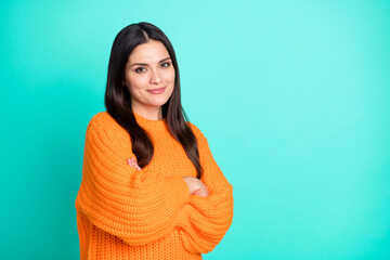 Photo of charming mature woman crossed arms look camera wear orange sweater isolated turquoise color background