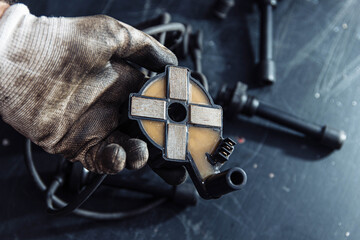 engine ignition coil in hand of auto mechanic