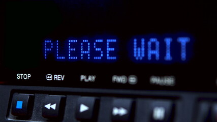 Disc player with screen. The word please wait is written on the screen.