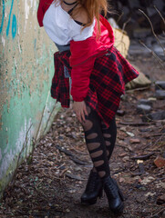 Seductive model in abandoned building wearing black leggings . Prostitute girl concept.