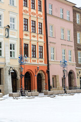 Fototapeta na wymiar Snowy winter in Krakow, Little Market Square with colorful tenement houses, Krakow, Poland