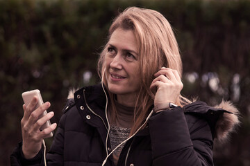 woman with headphones and mobile phone isolated on background