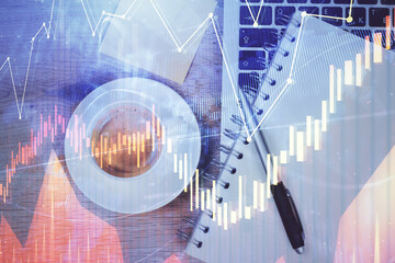 Double exposure of forex chart drawing over table background with computer. Concept of financial research and analysis. Top view.