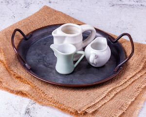 Three portion jugs for cream or milk on vintage metal tray