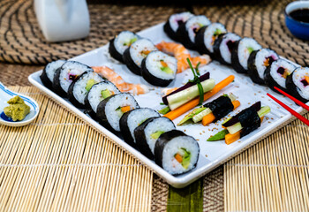 homemade sushi traditional japanese master making healthy maki rolls with prawns cucumber carrot...