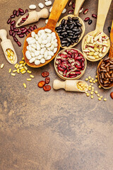 Set of various dry legumes in wooden spoons as indispensable protein for a healthy life