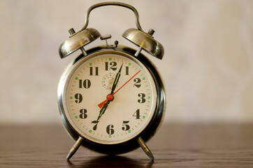 Alarm clock standing on the bedside table.