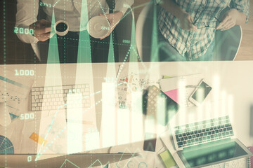 Double exposure of man and woman working together and financial chart hologram drawing. market analysis concept. Computer background. Top View.