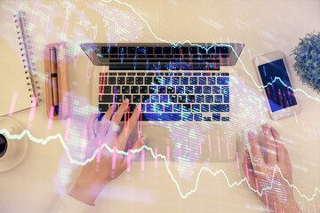 Double exposure of woman hands working on computer and forex chart hologram drawing. Top View. Financial analysis concept.