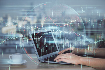 Double exposure of businesswoman hands typing on computer and forex chart hologram drawing. Financial analysis concept.