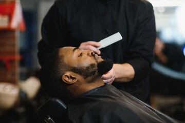 Young African-american man visiting barbershop