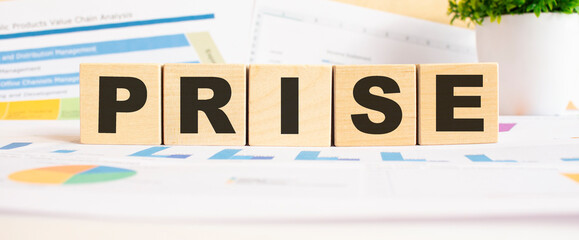 PRISE word on wooden cubes. The background is a business graphs. Business and finance concept