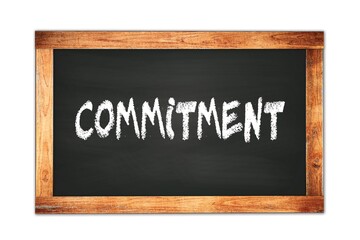Obraz premium COMMITMENT text written on wooden frame school blackboard.