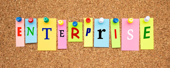 Color notes with letters pinned on a board. Word ENTERPRISE.