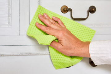 Cleaning hand with cloth at the dresser