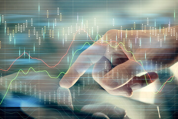 Multi exposure of man's hands holding and using a digital phone and forex graph drawing. Financial market concept.