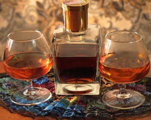 Two glasses and a bottle of cognac on the table