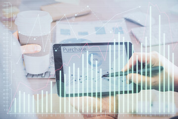 Double exposure of man's hands holding and using a phone and financial chart drawing. Market analysis concept.