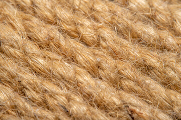 A background of roughly knitted fabric in soft focus under high magnification. Synthetic fabric stylized as an old, chunky-knit linen thread.