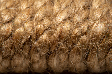 A background of roughly knitted fabric in soft focus under high magnification. Synthetic fabric stylized as an old, chunky-knit linen thread.