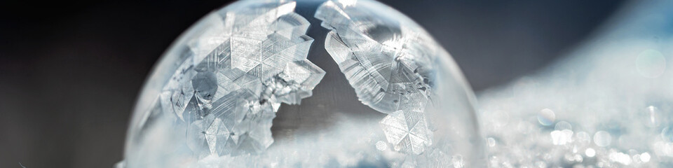 frozen bubble with bokeh background. Beautiful frosty patterns on frozen soap bubble. winter, frosty background. Macro photo