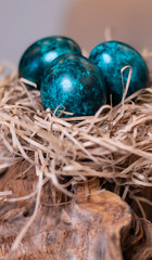 Dyed eggs in dark tidewater green tones. Easter festive background, open card, eggs close-up. Table setting for the Easter holiday. Christ is Risen Easter holiday.